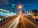 The Kingdom Tower, left, stands alongside the King Fahd highway, illuminated by the light trails of passing traffic, in Riyadh, Saudi Arabia.