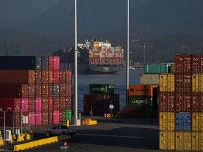Statistics Canada says the country posted a merchandise trade surplus in March of $972 million as imports fell more than exports. Cargo containers are seen stacked at the Port of Vancouver Centerm container terminal as the container ship MSC Lily sits at anchor in the harbour, in Vancouver, on Friday, October 14, 2022.