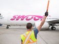 A Swoop plane arrives at the Regina International Airport. A tentative deal reached with pilots would see the discount carrier's flight operations integrated into those of WestJet.