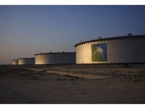 A company logo sits on the side of a crude oil storage tank at the Juaymah tank farm at Saudi Aramco's Ras Tanura oil refinery and oil terminal in Ras Tanura, Saudi Arabia, on Monday, Oct. 1, 2018. Saudi Aramco aims to become a global refiner and chemical maker, seeking to profit from parts of the oil industry where demand is growing the fastest while also underpinning the kingdom's economic diversification. Photographer: Simon Dawson/Bloomberg