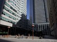 A pedestrian walks past an outdoor seating area at Brookfield Place in the financial district of Toronto.