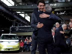 Prime Minister Justin Trudeau embraces Minister of Innovation, Science and Industry Francois-Philippe Champagne during a news conference to announce details on the construction of a gigafactory for electric vehicle battery production by Volkswagen Group's battery company PowerCo SE in St. Thomas, Ontario on April 21.