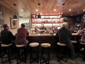 FILE - Patrons sit in a hotel bar in Eau Claire, Wis., May 1, 2019. Fourteen-year-olds in Wisconsin could serve alcohol to seated customers in bars and restaurants under a bill circulated for cosponsors Monday, May 1, 2023, by a pair of Republican state lawmakers.