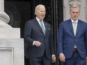 FILE - President Joe Biden talks with House Speaker Kevin McCarthy, R-Calif., as he departs the Capitol following the annual St. Patrick's Day gathering, in Washington, March 17, 2023. Facing the risk of a federal government default as soon as June 1, President Joe Biden has invited the top four congressional leaders to a White House meeting on May 9 for talks. It's the first concrete step toward negotiations on averting a potential economic catastrophe, but there's a long way to go: Biden and Republicans can't even agree on what's up for negotiation.