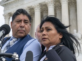 FILE - Beatriz Gonzalez, right, the mother of 23-year-old Nohemi Gonzalez, a student killed in the Paris terrorist attacks, and stepfather Jose Hernandez, speak outside the Supreme Court, Feb. 21, 2023, in Washington. The Supreme Court on Thursday, May 18, sidestepped a case against Google that might have allowed more lawsuits against social media companies. The justices' decision returns to a lower court the case from the family of Nohemi Gonzalez. The family wants to sue Google for YouTube videos they said helped attract IS recruits and radicalize them. Google owns YouTube.