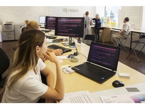 Employees read a ransomware demand for the payment of $300 worth of bitcoin on company computers infected by the 'Petya' software virus inside a retail store in Kiev, Ukraine, on Wednesday, June 28, 2017. The cyberattack similar to WannaCry began in Ukraine Tuesday, infecting computer networks and demanding $300 in cryptocurrency to unlock their systems before spreading to different parts of the world.
