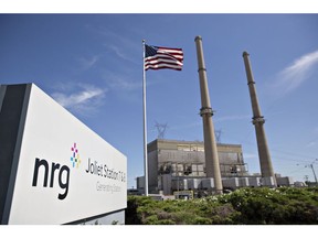 An American flag flies outside the NRG Energy Inc. Joliet Generating Station in Joliet, Illinois, U.S., on Wednesday, July 26, 2017. Coal-fired power plants employ more people than mines, and they're shutting down all over the country. Cheap natural gas, the rise of renewables backed by tax credits, and subsidies for nuclear energy will likely combine to keep the trend going and leave more people out of work. Photographer: Daniel Acker/Bloomberg