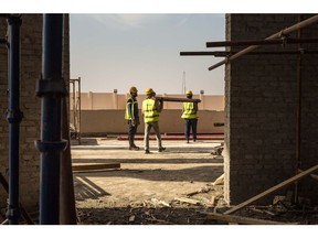 Construction work takes place at the site of the 'Christmas' cathedral, a new orthodox church, in the new Cairo Administrative Capital near Cairo, Egypt, on Tuesday, Feb. 20, 2018. The multiphase project envisages transforming a 700-square-kilometer swath of desert into a hub for Parliament, government ministries, foreign embassies, and major companies, easing pressure on traffic-choked Cairo. Photographer: Sima Diab/Bloomberg