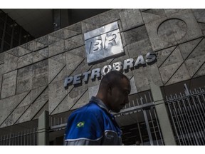 A pedestrian walks past Petrobras headquarters in Rio de Janeiro
