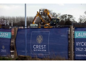 The Crest Nicholson Holdings Plc company logo on the external fencing to a new housing development in Maldon, U.K., on Thursday, Jan. 21, 2021. House prices boomed during 2020, reaching a record high in December as a tax cut spurred Brits to upgrade their living situations after months of working from home.