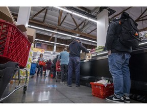 Shoppers at a supermarket checkout in San Francisco. Photographer: David Paul Morris/Bloomberg