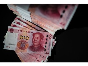 Chinese one-hundred yuan banknotes arranged in Hong Kong, China, on Tuesday, Oct. 18, 2022. China's central bank halted its cash withdrawal via medium term loans for the first time in three months in a bid to boost the economy as the Communist Party's twice-a-decade leadership congress gets underway.