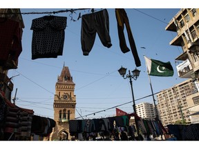 Clothes are on display among the electricity cables outside Empress Market in Karachi, Pakistan, on Monday, Oct. 24, 2022.  Source: Bloomberg