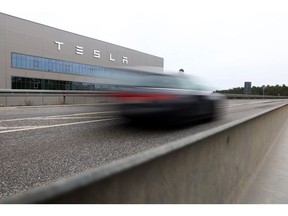 An automobile travels past the Tesla Inc. Gigafactory in Gruenheide, Germany, on Saturday, Jan. 21, 2023. Tesla CEO Elon Musk played down how much impact his tweets have on the company's stock price as he defended himself at a trial in San Francisco federal court on Friday over his 2018 tweet about taking the electric car-maker private. Photographer: Liesa Johannssen/Bloomberg
