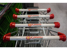 Branded shopping carts outside a Casino supermarket, operated by Casino Guichard-Perrachon SA, in central Paris, France, on Wednesday, April 12, 2023. The fate of Casino now rests on a deal with Teract SA's Moez-Alexandre Zouari, who got his start two decades ago running supermarkets under franchises from Jean-Charles Naouri's company, and whether the two men can pull off a merger of two retail groups.