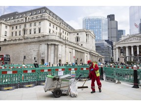 A street cleaner sweeps the pavement outside the Bank of England in City of London, UK, on Monday, May 15, 2023. The upcoming batch of jobs data, due on Tuesday, May 16, is likely to show price pressures in the economy remain way too high for the Bank of England to tolerate.