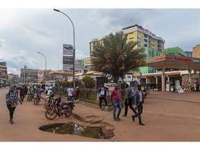 A pothole in the road outside a TotalEnergies SE gas station in Kampala, Uganda, on Wednesday, May 17, 2023. Uganda estimates that it will need $28.1 billion to adapt to the effects of climate change and cut emissions until the end of the decade. Photographer: Katumba Badru Sultan/Bloomberg