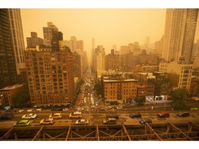 NEW YORK, NEW YORK - JUNE 7: Traffic moves over the Ed Koch Queensboro Bridge as smoke from Canadian wildfires casts a haze over the area on June 7, 2023 in New York City. Air pollution alerts were issued across the United States due to smoke from wildfires that have been burning in Canada for weeks.