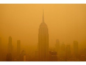 NEW YORK, NEW YORK - JUNE 7: Smoky haze from wildfires in Canada diminishes the visibility of the Empire State Building on June 7, 2023 in New York City. New York topped the list of most polluted major cities in the world on Tuesday night, as smoke from the fires continues to blanket the East Coast.