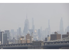 Buildings shrouded in smoke from Canada wildfires beyond the Manhattan Bridge in New York on June 6.