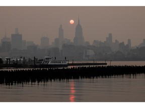 Buildings in the Manhattan skyline shrouded in smoke from Canada wildfires at sunrise in Jersey City, New Jersey, US, on Wednesday, June 7, 2023. New York was the most polluted major city in the world on Tuesday night, as smoke from Canadian wildfires blanketed the city in haze, according to the IQAir website.