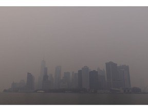 Buildings in Lower Manhattan shrouded in smoke from Canada wildfires in New York, US, on Wednesday, June 7, 2023. The US Northeast, including New York City, will continue to breathe in choking smoke from fires across eastern Canada for the next few days, raising health alarms across impacted areas.