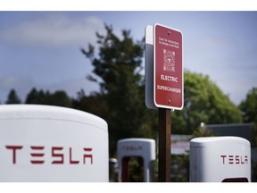 A sign informs customers how to charge their non-Tesla vehicles at a Tesla Supercharger location in Scotts Valley, California, US, on Thursday, June 1, 2023. Tesla is making its ubiquitous Superchargers available to other EVs through new corporate partnerships and its Magic Dock.