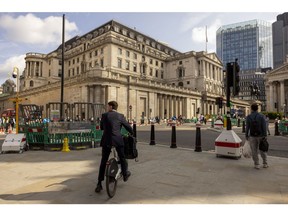 A commuter stops on a hire bike outside the Bank of England (BOE) in the City of London, UK, on Monday, June 19, 2023. The squeeze on finances for thousands of British homeowners is set to intensify after a key rate on mortgage borrowing climbed to its highest level since December.