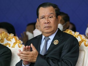 FILE - Cambodian Prime Minister Hun Sen claps during the 71st anniversary celebration of the Cambodian People's Party (CPP) at its headquarters in Phnom Penh, Cambodia, Tuesday, June 28, 2022. A quasi-independent review board has recommended that Facebook suspend that Cambodian Prime Minister Hun Sen's Facebook and Instagram accounts for six months for using language that could incite violence.
