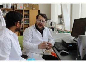 (Left to right) Tharindu Suraweera-Arachchilage – Bio Manufacturing Scientist I, and Roger Gumbau-Brisa - Carbon Transformation Senior Scientist, analyzing data in the Verschuren Centre testing lab, Sydney, NS.