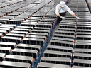 A worker adjusts car batteries at a factory in Nanjing, China, that makes lithium batteries for electric cars and other uses. 