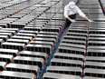 A worker adjusts car batteries