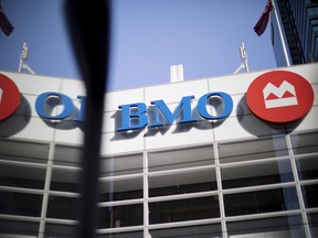 A Bank of Montreal (BMO) sign is reflected on a surface in the financial district of Toronto.