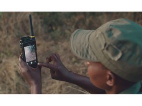 Ranger Theressa Makunike uses a Hytera dual-mode radio to record plants in the parks