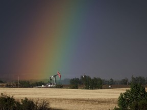A pumpjack draws out oil and gas from a well head as a rainbow shines down on it near Calgary, Alta., Sunday, May 28, 2023. New modelling from the Canada Energy Regulator suggests Canadian oil production will plummet by 2050 if the world achieves net-zero greenhouse gas emissions within that time.