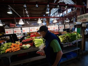 A person shops for produce at a market in Vancouver.