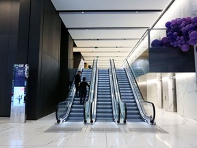 People use an escalator in the main foyer at the Brookfield Place Sydney office building, owned and home to the Asia-Pacific headquarters of Brookfields Asset Management Inc., in Sydney, Australia.