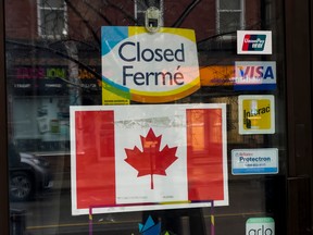 A closed sign on a store window in Ottawa