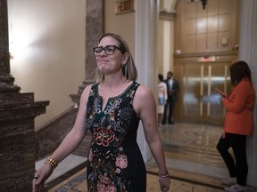Sen. Kyrsten Sinema, I-Ariz., shuttles between the chamber and the whip office as the Senate dashes to wrap up votes on amendments on the big debt ceiling and budget cuts package, at the Capitol in Washington, Thursday, June 1, 2023.