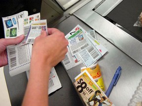 A shopper sorts through coupons at a check-out counter. Consumers need to allocate time, effort and funds to planning, budgeting and shopping during high inflation.