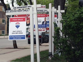 Real estate signs in front of a condominium in Winnipeg.