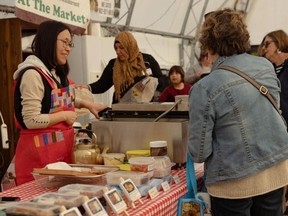 A Korean vendor sells food at the Farmer's Market in downtown New Glasgow, Pictou County, Nova Scotia, in May.