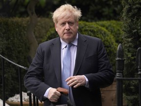 FILE - Boris Johnson leaves his house in London, on March 22, 2023. Several dozen allies of former British Prime Minister Boris Johnson received honors from King Charles III on Friday June 9, 2023, a list that drew cries of cronyism from opponents of the ousted leader. 