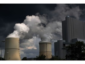 Emissions rise from cooling towers at a lignite fueled power plant in Germany. Photographer: Bloomberg Creative Photos/Bloomberg