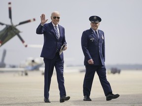 President Joe Biden walks to board Air Force One, escorted by Air Force Col. Paul Pawluk, Wednesday, June 28, 2023, at Andrews Air Force Base, Md. The President is traveling to Chicago to deliver remarks on the economy.