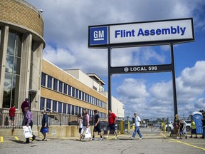 People arrive at the Flint Assembly Plant for a free tour and open house, Aug. 11, 2015, in Flint, Mich. General Motors plans to invest more than $1 billion in two Flint, Michigan manufacturing plants for the production of the next-generation internal combustion engine heavy-duty trucks. Gerald Johnson, executive vice president, Global Manufacturing and Sustainability, said Monday, June 5, 2023 that the company will build internal combustion vehicles throughout this decade, in addition to making electric vehicles.