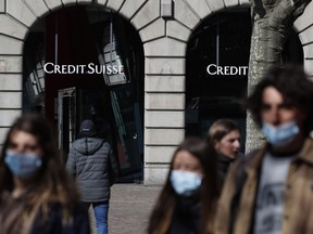 Pedestrians pass by a Credit Suisse Group AG bank branch in Zurich, Switzerland.