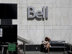 A women reads outside a Bell Canada office in Toronto.