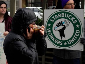 A person walks past a Starbucks Workers Union strike outside a Starbucks coffee shop in the Chelsea neighbourhood of New York City.