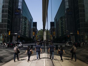 Pedestrians walk in the financial district of Toronto.